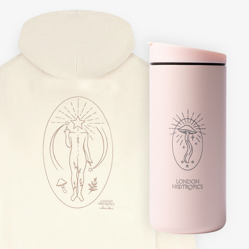 White Find Your Flow zip hoodie pictured from behind next to a blush pink MiiR travel cup, featuring London Nootropics Mushroom designs, on a white background.