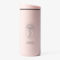 London Nootropics branded blush pink travel mug by MiiR. The London Nootropics design features a mushroom at the centre of a lined-oval shape with whimsical elements like stars and sparkles.