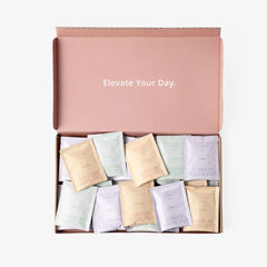 London Nootropics pink mixed coffee box that reads "elevate your day" on the inner lid, open and full of mixed coffee 