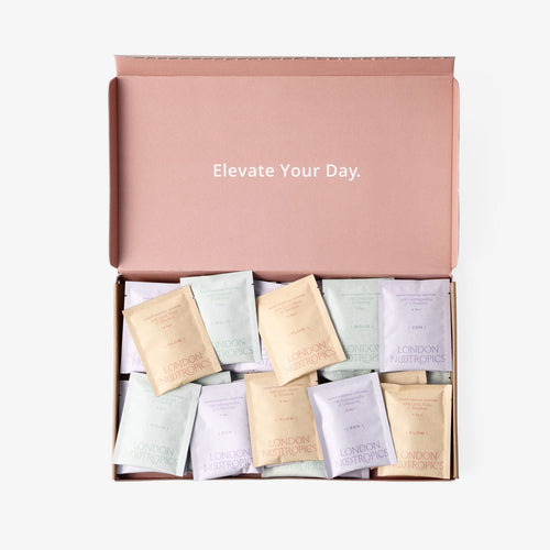 London Nootropics pink mixed coffee box that reads "elevate your day" on the inner lid, open and full of mixed coffee 