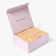 Open pink London Nootropics coffee box full of orange Flow adaptogen coffee sachets