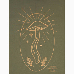 Close-up image of London Nootropics Mushroom Rising Zip Hoodie in khaki green. The design features an oval and a mushroom at the centre. The bottom right corner features the nootropics logo and designer signature.